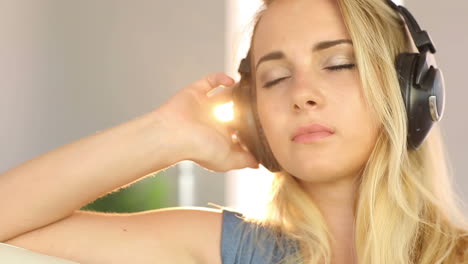 Beautiful-blonde-teen-relaxing-and-listening-to-music