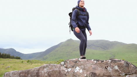Fit-woman-reaching-the-summit-and-looking-around