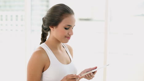 Fit-young-woman-using-her-digital-tablet