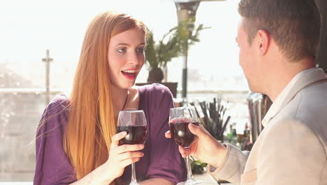 Loving-couple-talking-while-having-glass-of-red-wine