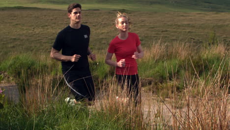 Athletic-couple-jogging-on-a-country-trail