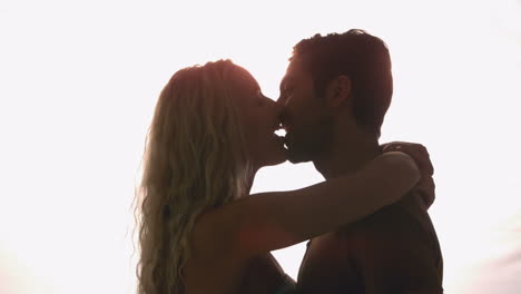 Couple-kissing-against-sunlight