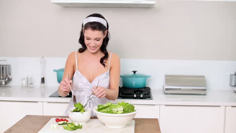 Beautiful-brunette-serving-up-a-healthy-salad