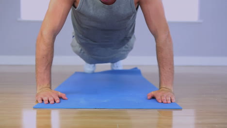 Handsome-sporty-man-doing-push-ups