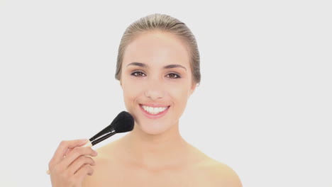 Beautiful-model-using-a-powder-brush-on-her-face