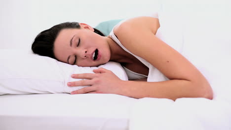 Peaceful-attractive-woman-sleeping-lying-in-her-bed-