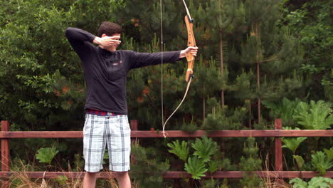 Athletic-man-shooting-a-bow-and-arrow