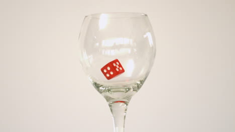 Two-red-dice-falling-in-glass-and-bouncing