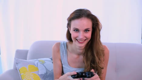 Smiling-model-playing-video-games-on-the-couch