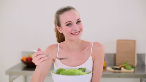 Smiling-model-eating-a-big-bowl-of-salad
