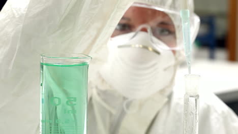 Science-student-in-protective-suit-working-with-chemicals