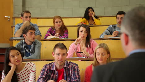 Student-raising-her-hand-to-ask-question-in-lecture