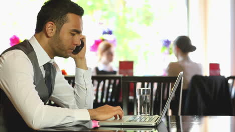 Handsome-businessman-working-on-his-laptop-