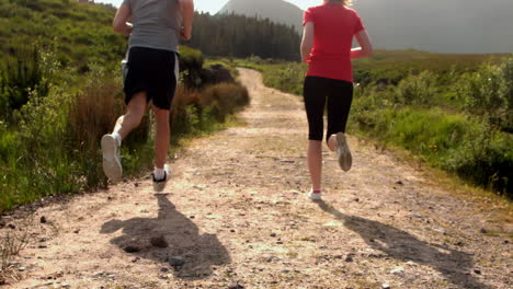 Fit-couple-jogging-together-in-the-countryside-away-from-camera