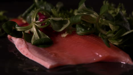 Lambs-lettuce-faling-over-fresh-trout-fillet