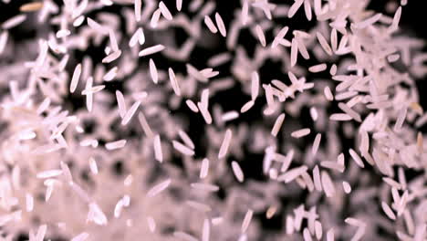 Rice-bouncing-against-black-background