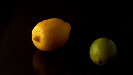 Lemon-and-lime-spinning-on-black-surface