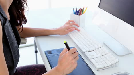 Graphic-designer-working-on-digitizer-at-her-desk