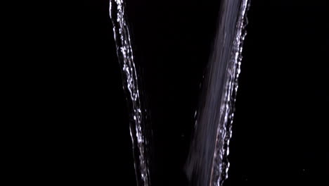 Water-pouring-against-black-background