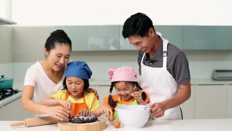 Smiling-parents-and-cute-daughters-baking-together