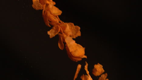 Cereal-flakes-falling-against-black-background