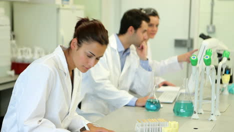 Chemistry-student-looking-up-from-her-work-and-smiling