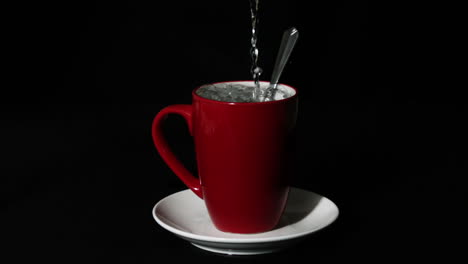 Hot-water-pouring-into-red-mug