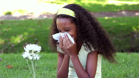 Young-girl-sneezing-from-hay-fever-in-the-park