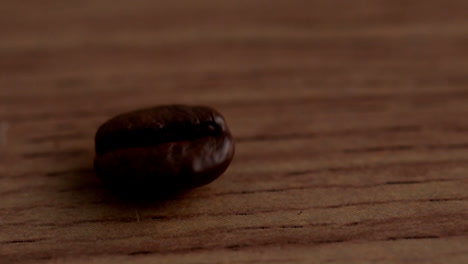 Coffee-beans-spinning-on-wooden-surface