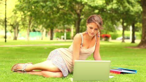 Happy-student-using-laptop-outside