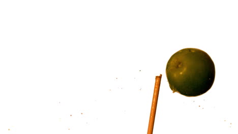 Arrow-shooting-through-green-apple-on-white-background