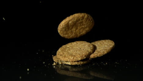 Biscuits-falling-on-black-surface