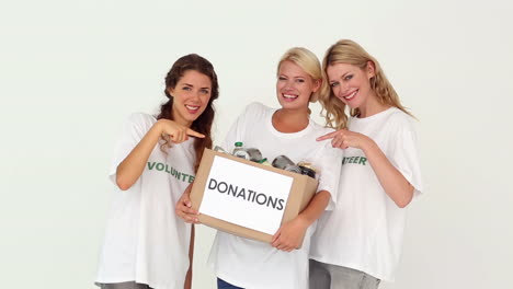 Team-of-volunteers-holding-donation-box