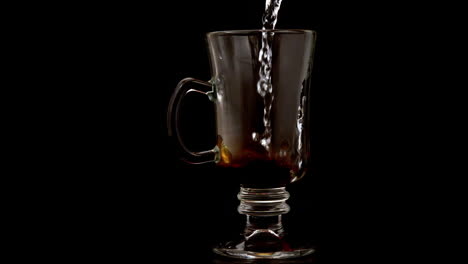 Hot-water-pouring-over-coffee-granules-in-a-glass