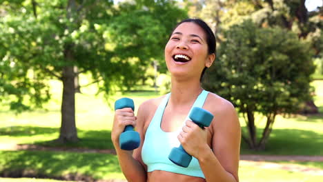 Fit-asian-girl-lifting-dumbbells