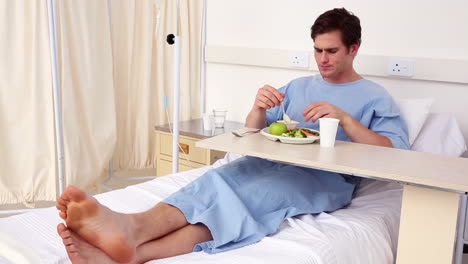 Patient-sitting-in-bed-having-his-lunch