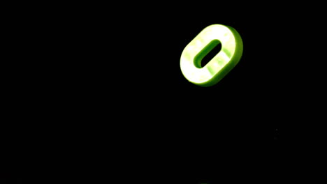 Green-number-zero-falling-on-black-background