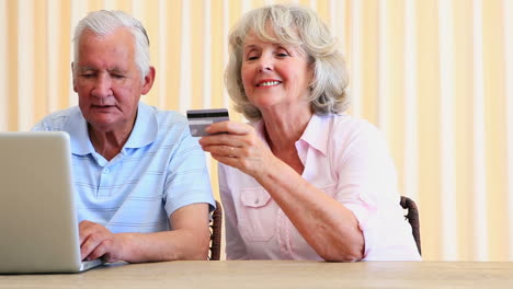 Senior-couple-paying-their-bills-with-laptop