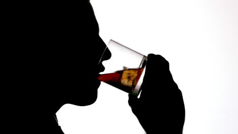 Silhouette-of-businessman-drinking-whiskey-on-white-background
