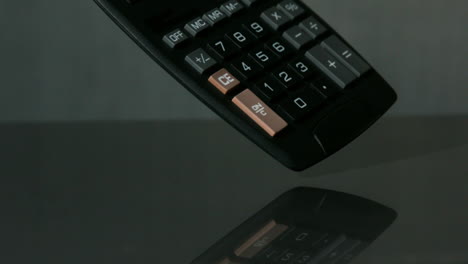 Calculator-falling-on-black-background