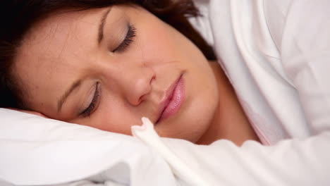 Pretty-brunette-lying-in-bed-sleeping