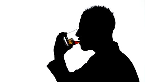 Silhouette-of-businessman-drinking-whiskey-on-white-background