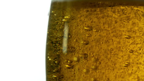 Glass-of-beer-bubbling-on-white-background