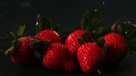 Water-drops-on-strawberries-on-black-surface