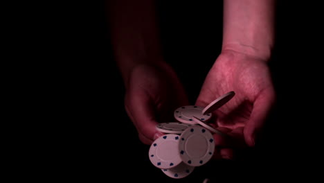 Poker-chips-falling-into-hands