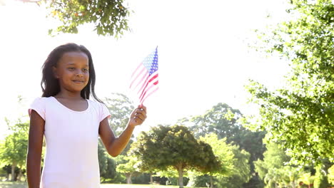Little-girl-waving-the-american-flag-