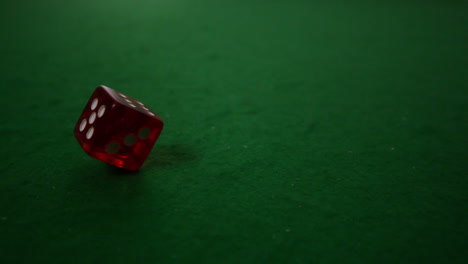 Red-dice-spinning-on-casino-table