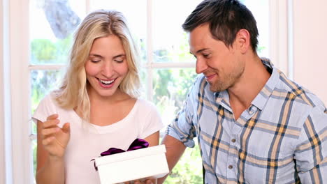 Man-surprising-his-girlfriend-with-a-gift