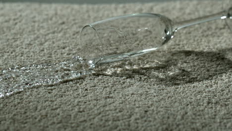 Wine-glass-of-water-spilling-on-carpet