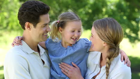 Happy-parents-with-their-little-girl-in-the-park